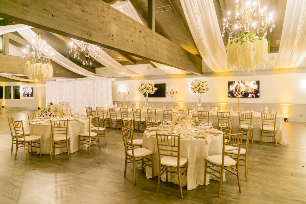 Various tables set for wedding dinner